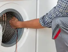 Dryer repair technician diagnosing and servicing a clothes dryer in Gilbert, AZ