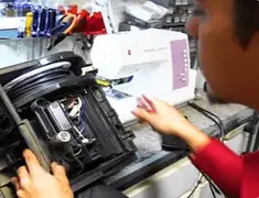 Vacuum repair technician servicing internal components on a workbench in Gilbert, AZ