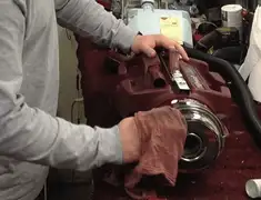 Vacuum repair technician cleaning and servicing a vacuum motor in Gilbert, AZ