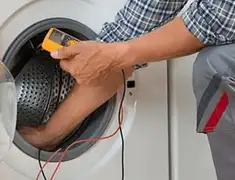 Washing machine repair technician testing a front-load washer with diagnostic tools in Gilbert, AZ